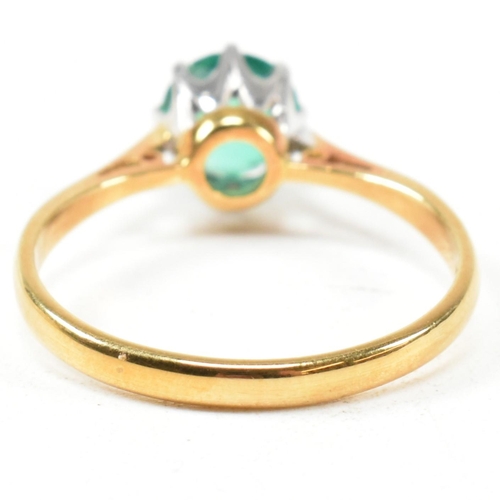 15 - A hallmarked 18ct gold and emerald solitaire ring. The ring set with a round mixed cut emerald. Hall... 