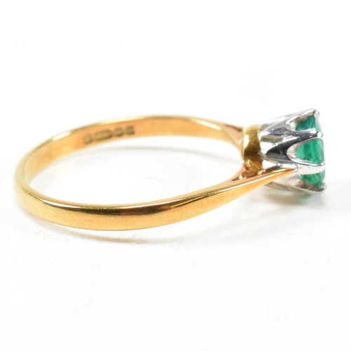 15 - A hallmarked 18ct gold and emerald solitaire ring. The ring set with a round mixed cut emerald. Hall... 