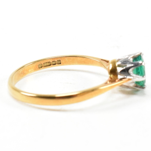 15 - A hallmarked 18ct gold and emerald solitaire ring. The ring set with a round mixed cut emerald. Hall... 