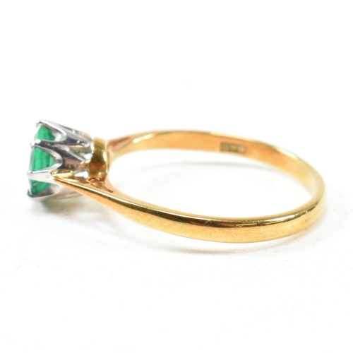 15 - A hallmarked 18ct gold and emerald solitaire ring. The ring set with a round mixed cut emerald. Hall... 