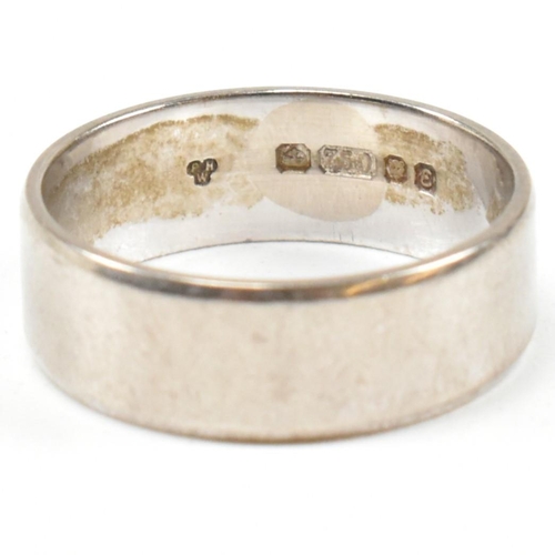 159 - A hallmarked 18ct white gold wide band ring. The ring hallmarked London. Weight 4.2g. Size J. All we... 