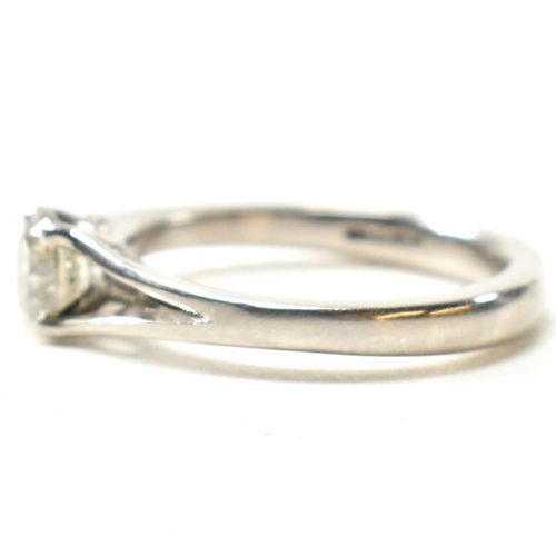 166 - A hallmarked platinum and diamond solitaire ring. The ring set with a single four claw set round cut... 