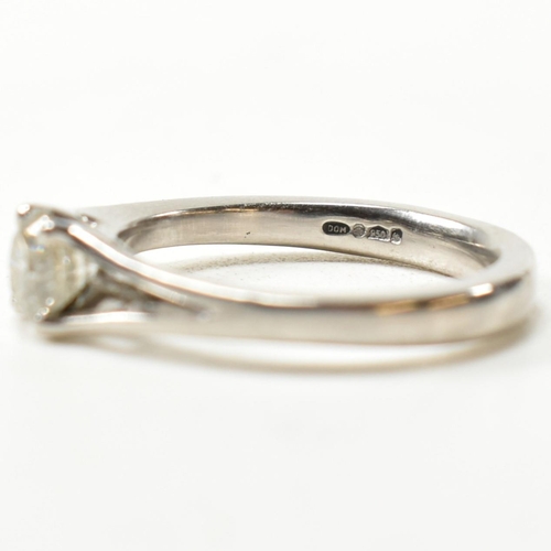 166 - A hallmarked platinum and diamond solitaire ring. The ring set with a single four claw set round cut... 