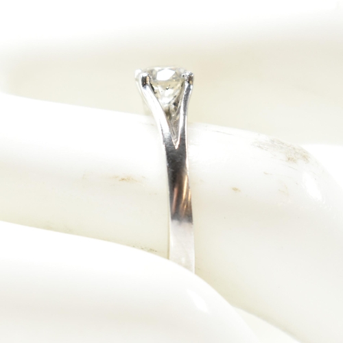 166 - A hallmarked platinum and diamond solitaire ring. The ring set with a single four claw set round cut... 