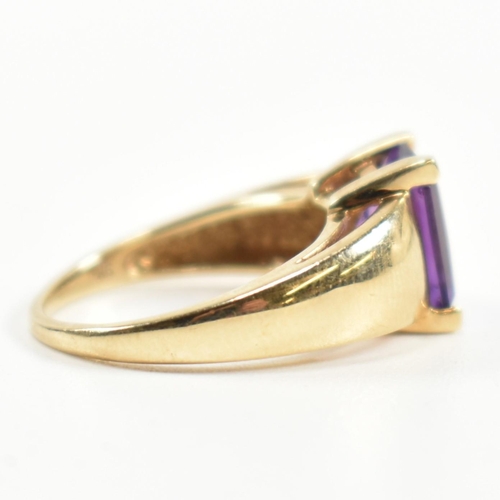 168 - A hallmarked 9ct gold and amethyst ring. The ring set with a central emerald cut amethyst in a domed... 