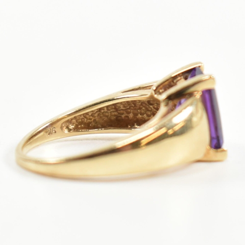 168 - A hallmarked 9ct gold and amethyst ring. The ring set with a central emerald cut amethyst in a domed... 