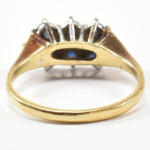 17 - A hallmarked 18ct gold, sapphire and diamond three layer ring. The ring set with two rows of three r... 