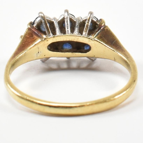 17 - A hallmarked 18ct gold, sapphire and diamond three layer ring. The ring set with two rows of three r... 