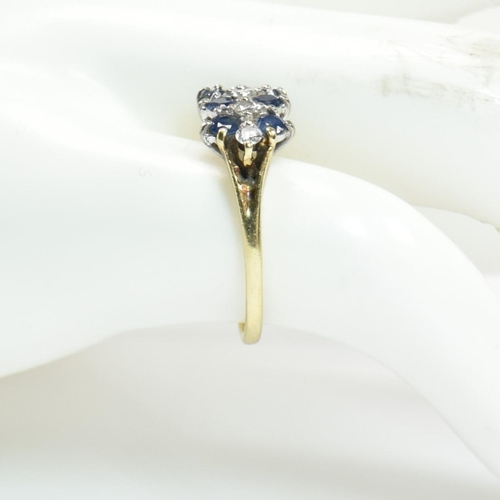 17 - A hallmarked 18ct gold, sapphire and diamond three layer ring. The ring set with two rows of three r... 