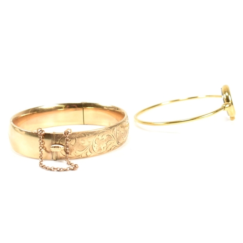 170 - A 9ct gold metal core hinged bangle and a gold tone metal bangle watch. The lot to include a 9ct gol... 