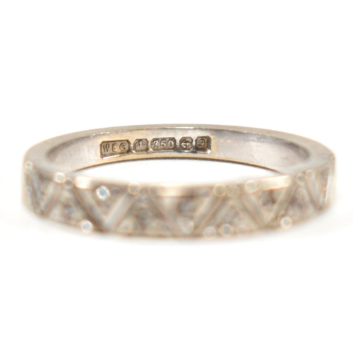 171 - A hallmarked 18ct white gold and diamond half eternity ring. The ring having a single row of nine il... 