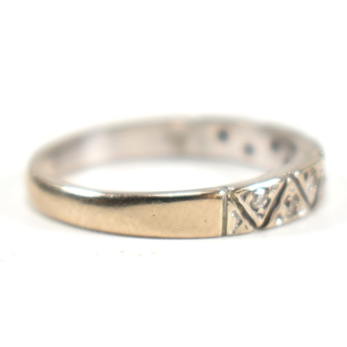 171 - A hallmarked 18ct white gold and diamond half eternity ring. The ring having a single row of nine il... 