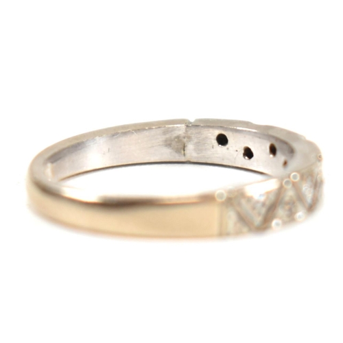 171 - A hallmarked 18ct white gold and diamond half eternity ring. The ring having a single row of nine il... 