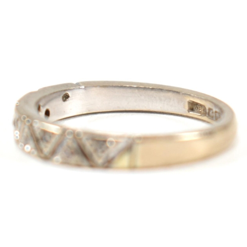 171 - A hallmarked 18ct white gold and diamond half eternity ring. The ring having a single row of nine il... 