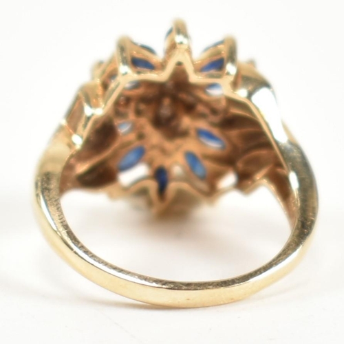 178 - A hallmarked 9ct gold, sapphire and diamond cluster ring. The ring having a central cluster of round... 