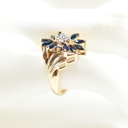 178 - A hallmarked 9ct gold, sapphire and diamond cluster ring. The ring having a central cluster of round... 