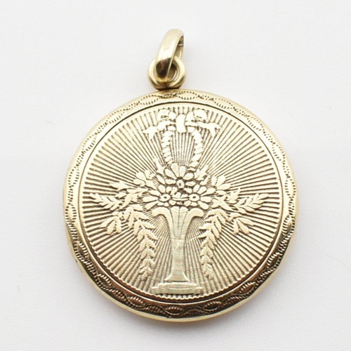 180 - A 14ct gold locket necklace pendant. The 14ct gold round locket pendant having a vase of flowers des... 