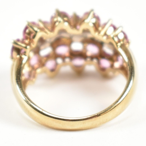 181 - A hallmarked 9ct gold, pink sapphire and diamond cluster ring. The ring set with sixteen round cut p... 