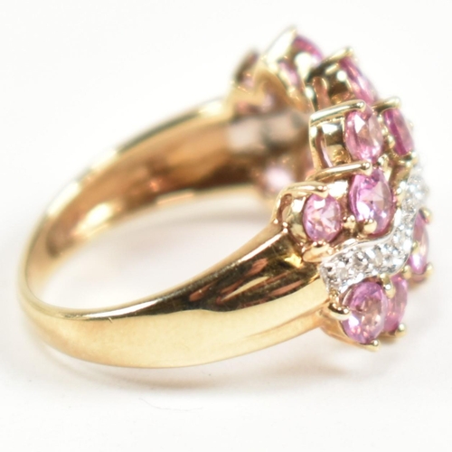 181 - A hallmarked 9ct gold, pink sapphire and diamond cluster ring. The ring set with sixteen round cut p... 