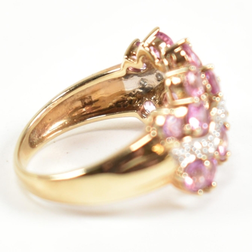 181 - A hallmarked 9ct gold, pink sapphire and diamond cluster ring. The ring set with sixteen round cut p... 