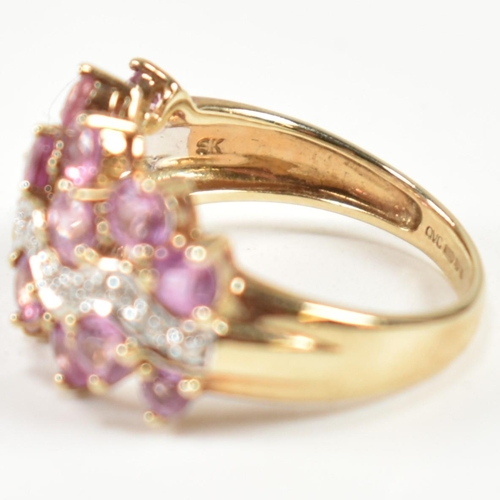 181 - A hallmarked 9ct gold, pink sapphire and diamond cluster ring. The ring set with sixteen round cut p... 