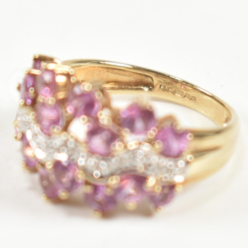 181 - A hallmarked 9ct gold, pink sapphire and diamond cluster ring. The ring set with sixteen round cut p... 