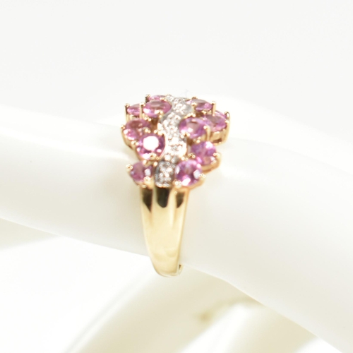 181 - A hallmarked 9ct gold, pink sapphire and diamond cluster ring. The ring set with sixteen round cut p... 