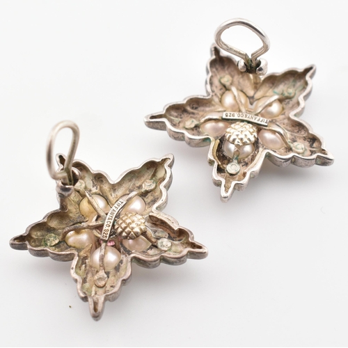 185 - A pair of Tiffany & Co silver, pearl and pink stone star ear clips. The Tiffany & Co clip-on earring... 