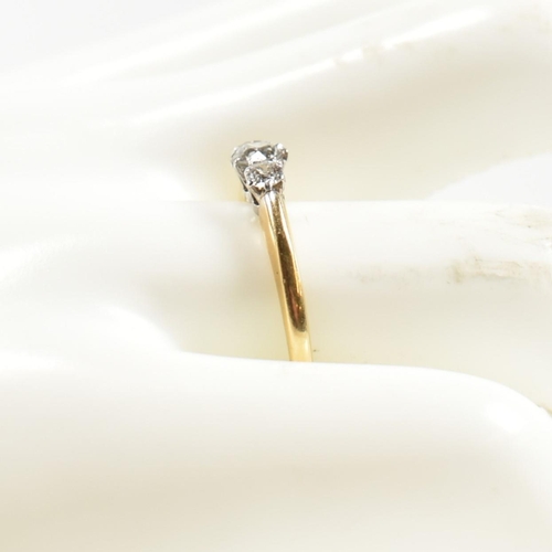 186 - An 18ct gold and diamond three stone ring. The ring having a central round brilliant cut diamond fla... 