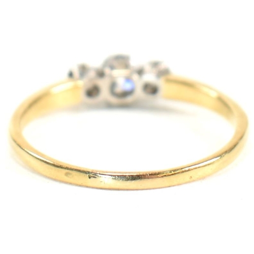 186 - An 18ct gold and diamond three stone ring. The ring having a central round brilliant cut diamond fla... 