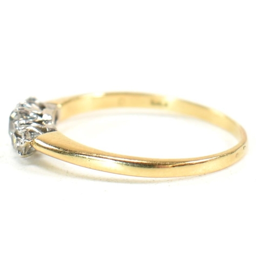 186 - An 18ct gold and diamond three stone ring. The ring having a central round brilliant cut diamond fla... 