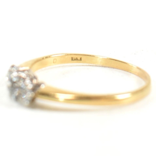 186 - An 18ct gold and diamond three stone ring. The ring having a central round brilliant cut diamond fla... 