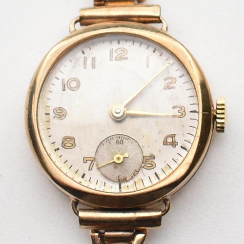 189 - A 9ct gold hallmarked ladies dress cocktail watch. Silvered dial with Arabic numbers. Set to a 9ct /... 