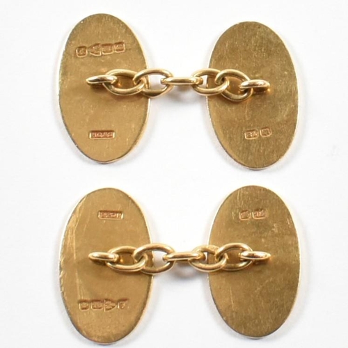 19 - A pair of hallmarked 18ct gold cufflinks. The cufflinks having oval decorated heads united by chain.... 