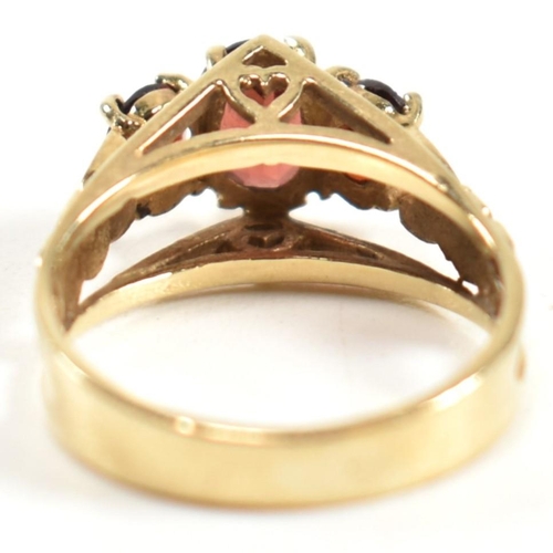 191 - A hallmarked 9ct gold and garnet trilogy ring. The ring set with three graduating four claw set oval... 