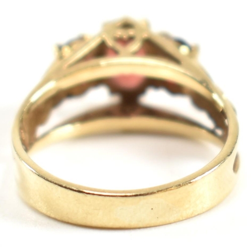 191 - A hallmarked 9ct gold and garnet trilogy ring. The ring set with three graduating four claw set oval... 