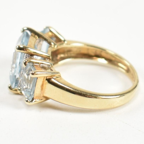 194 - A hallmarked 9ct gold aquamarine and diamond trilogy ring. The ring set with a central four claw set... 