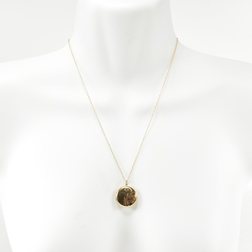 195 - A hallmarked 9ct gold a locket pendant necklace. The necklace strung with a round locket having foli... 