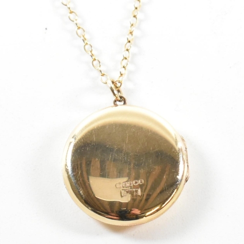 195 - A hallmarked 9ct gold a locket pendant necklace. The necklace strung with a round locket having foli... 