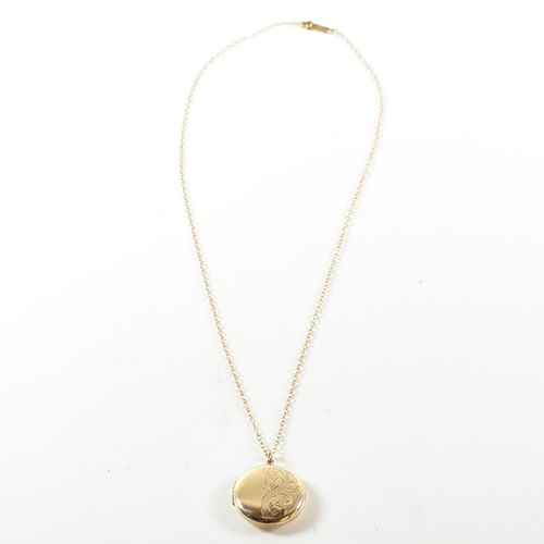 195 - A hallmarked 9ct gold a locket pendant necklace. The necklace strung with a round locket having foli... 