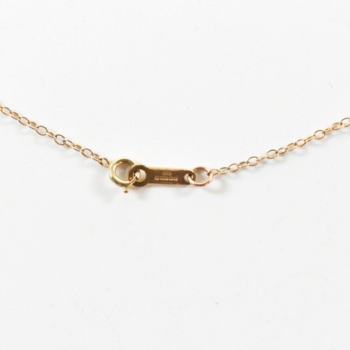 195 - A hallmarked 9ct gold a locket pendant necklace. The necklace strung with a round locket having foli... 