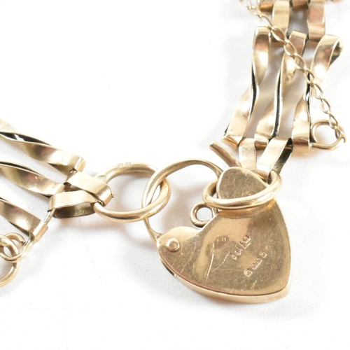 197 - A hallmarked 9ct gold twisted gate link bracelet with heart padlock clasp. The 9ct gold gate link br... 