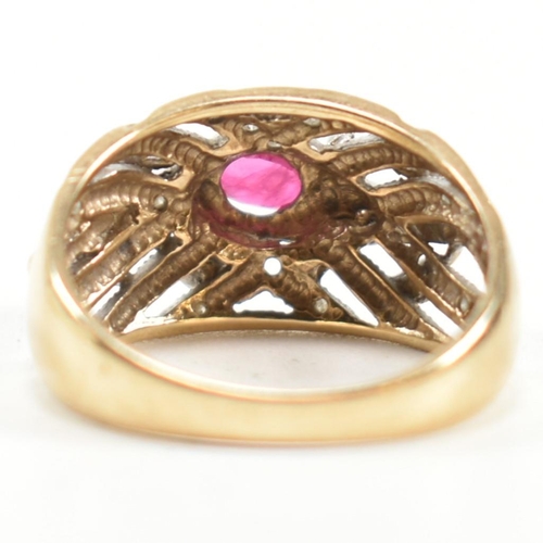 200 - A hallmarked 9ct gold, ruby and diamond ring. The ring having a central four claw set east-west oval... 