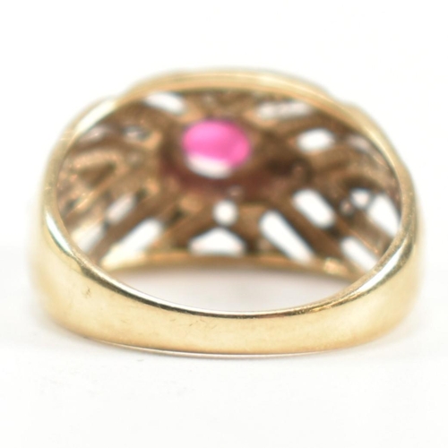 200 - A hallmarked 9ct gold, ruby and diamond ring. The ring having a central four claw set east-west oval... 