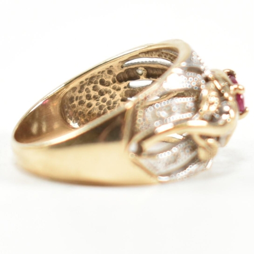 200 - A hallmarked 9ct gold, ruby and diamond ring. The ring having a central four claw set east-west oval... 