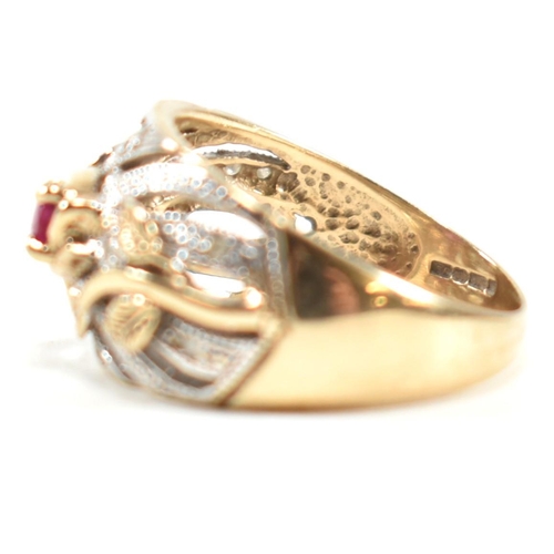 200 - A hallmarked 9ct gold, ruby and diamond ring. The ring having a central four claw set east-west oval... 