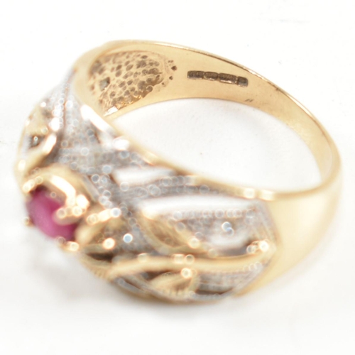 200 - A hallmarked 9ct gold, ruby and diamond ring. The ring having a central four claw set east-west oval... 