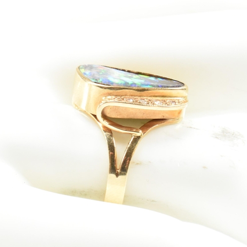 201 - An 18ct gold opal and diamond ring. The ring set with an opal doublet having four single cut diamond... 