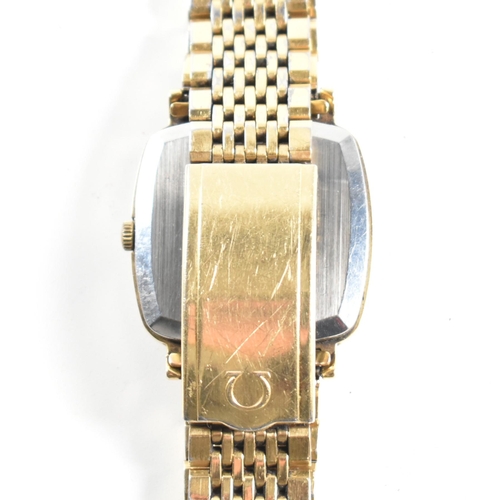 208 - An Omega Genève triple gold metal gentleman's wrist watch. The Omega Genève watching having gold lac... 