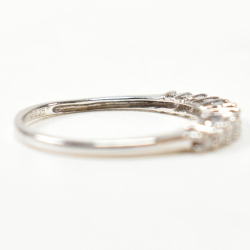 212 - A hallmarked 9ct white gold and diamond half hoop ring. The ring having a single row of eleven round... 